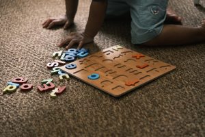 child-playing-with-alphabet-puzzle-on-carpet-3xa4jzixxa0