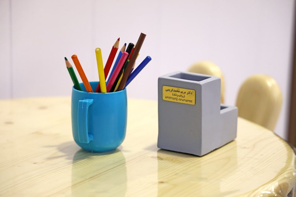 colored-pencils-in-a-blue-cup-next-to-holder-fpj4ev15eyi colored-pencils-in-a-blue-cup-next-to-holder-fpj4ev15eyi